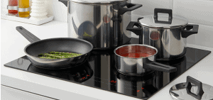 photo of a variety of saucepans, stockpot and frypan on glass cooktop