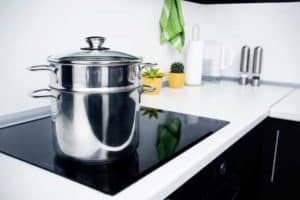a saucepan and steamer on a built-in induction hob