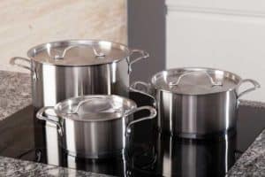 3 piece stainless steel saucepans on an induction cooktop