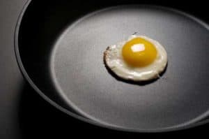 frying an egg to demonstrate non stick frypan qualities
